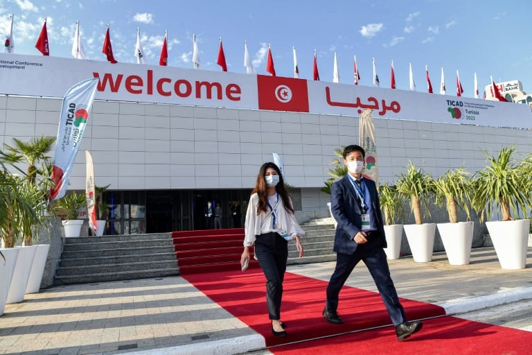 Attendees walk outside the Congress Palace