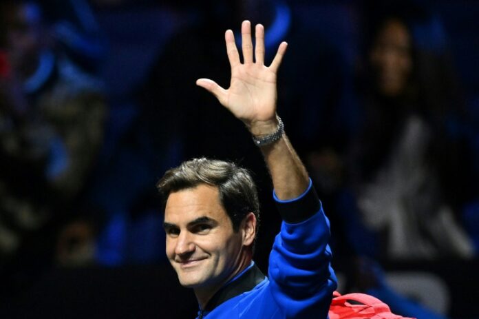 Roger Federer waves to the crowd after a practice session for the 2022