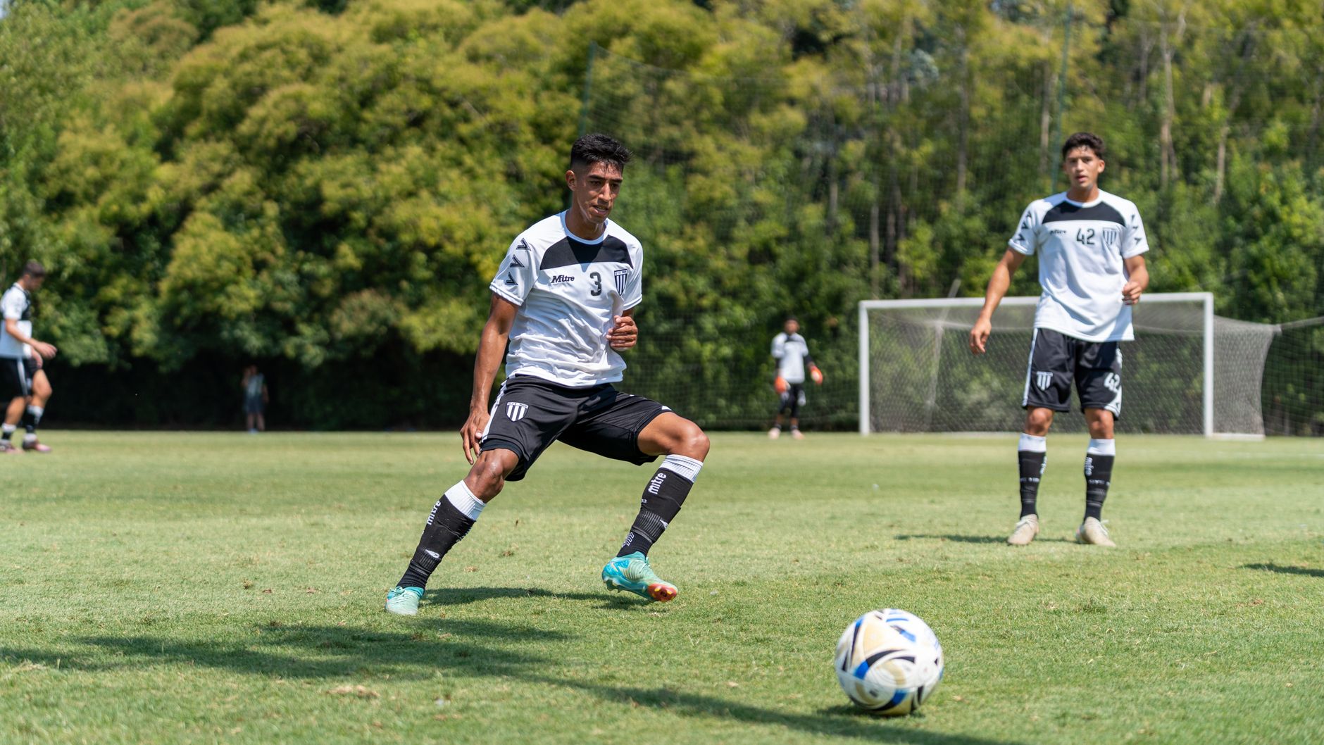 Exciting soccer match on a bright day with players in motion capturing the competitive spirit.